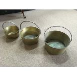 Three graduated size brass jam kettles with cast iron handles. IMPORTANT: Online viewing and bidding