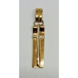 A hallmarked 18ct yellow gold articulated cross pendant comprising of three sections, jump ring