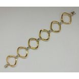 An open metalwork link bracelet, stamped 750, length approx. 19cm, weight approx. 40.3g.