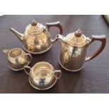 An Art Deco silver four piece tea set, comprising a tea pot, water pot, sugar bowl and milk jug,