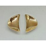 A pair of shaped clip-on earrings, stamped 375, weight approx. 9.1g. IMPORTANT: Online viewing and