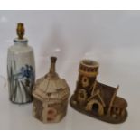 A Colin Kellam studio pottery lamp base, 30cm, and two studio pottery buildings with marks to