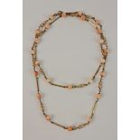 A coral bead and open metalwork link necklace, unmarked yellow metal, length approx. 80cm, weight