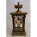 An Ansonia New York clock with onyx base and top, brass fittings to four glass panels and and