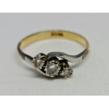 A three stone diamond ring, set with three graduated round brilliant cut diamonds, total diamond