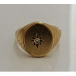 A hallmarked 9ct yellow gold gents signet ring with central star set diamond approx. 0.07cts, ring