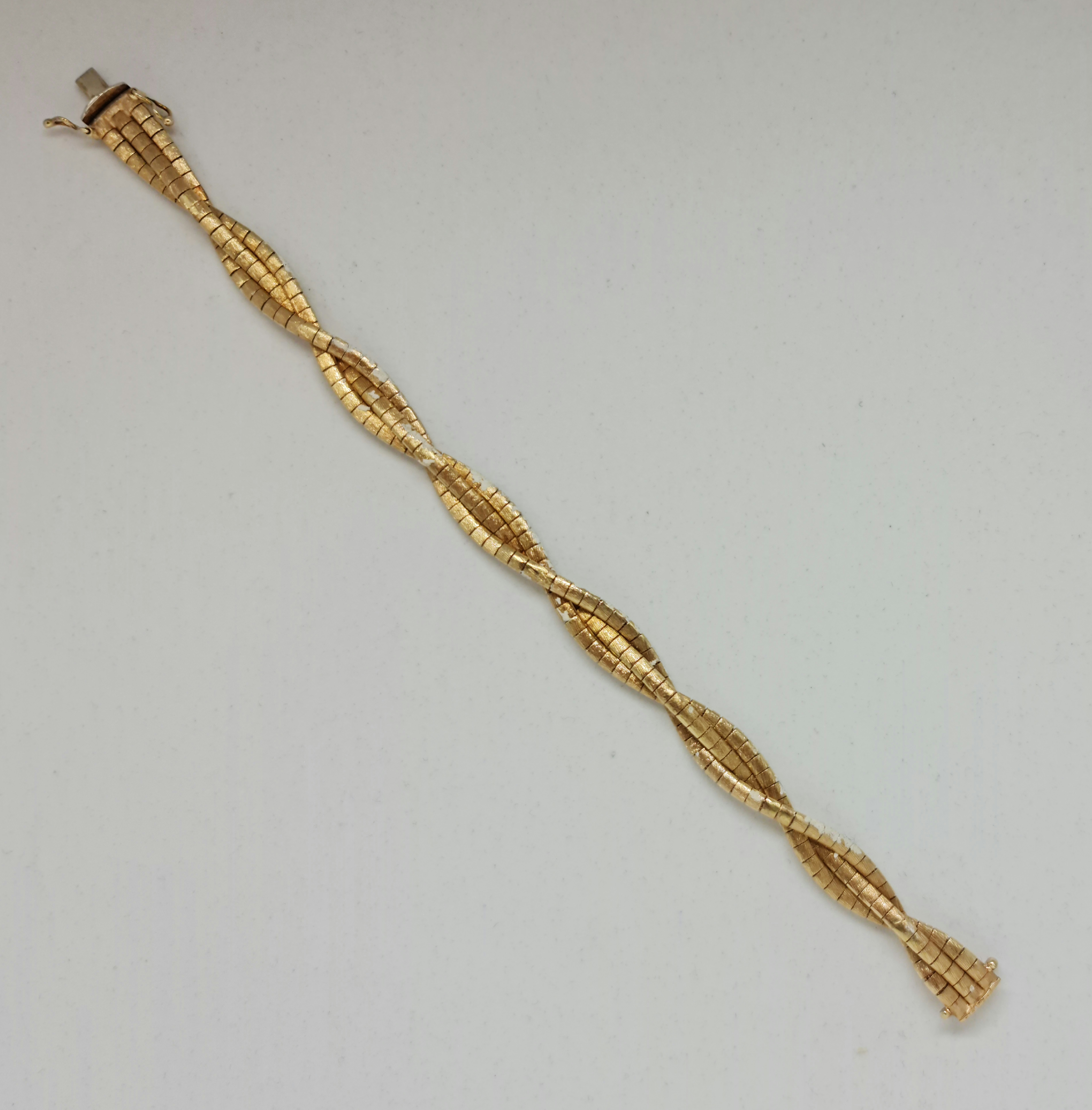 A fancy cross over three strand bracelet, stamped 585, length approx. 19cm, weight approx. 20.6g.