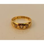 A Victorian 18ct yellow gold diamond three stone ring, star set with three old cut diamonds, total