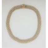 An 18ct yellow and white gold necklace, comprising yellow gold circle links joined together with