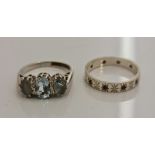A hallmarked 9ct white gold three stone aquamarine ring, ring size I, approx. weight 3.2gms. and a