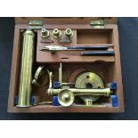 An Elliott Bros London small microscope set in wooden case.