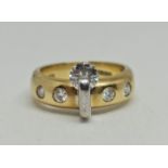 An 18ct yellow and white gold contemporary diamond ring, set with a principal round brilliant cut