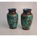 A pair of cloisonné vases with oriental birds in tree design on green background, heights approx.