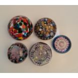 A selection of five paperweights in various designs including Perth 1973 millefiori design with