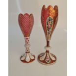 Two bohemian style cameo cranberry glass vases, both with gold detail, one with floral design,