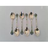 A set of six hallmarked silver and enamel spoons with flower design on handle, approx. weight 53.