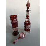 A selection of bohemian style cranberry glass to include decanter with stopper and vase, both with