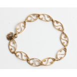 An open metalwork scroll link bracelet, clasp stamped 9ct, length approx. 19cm. IMPORTANT: Online