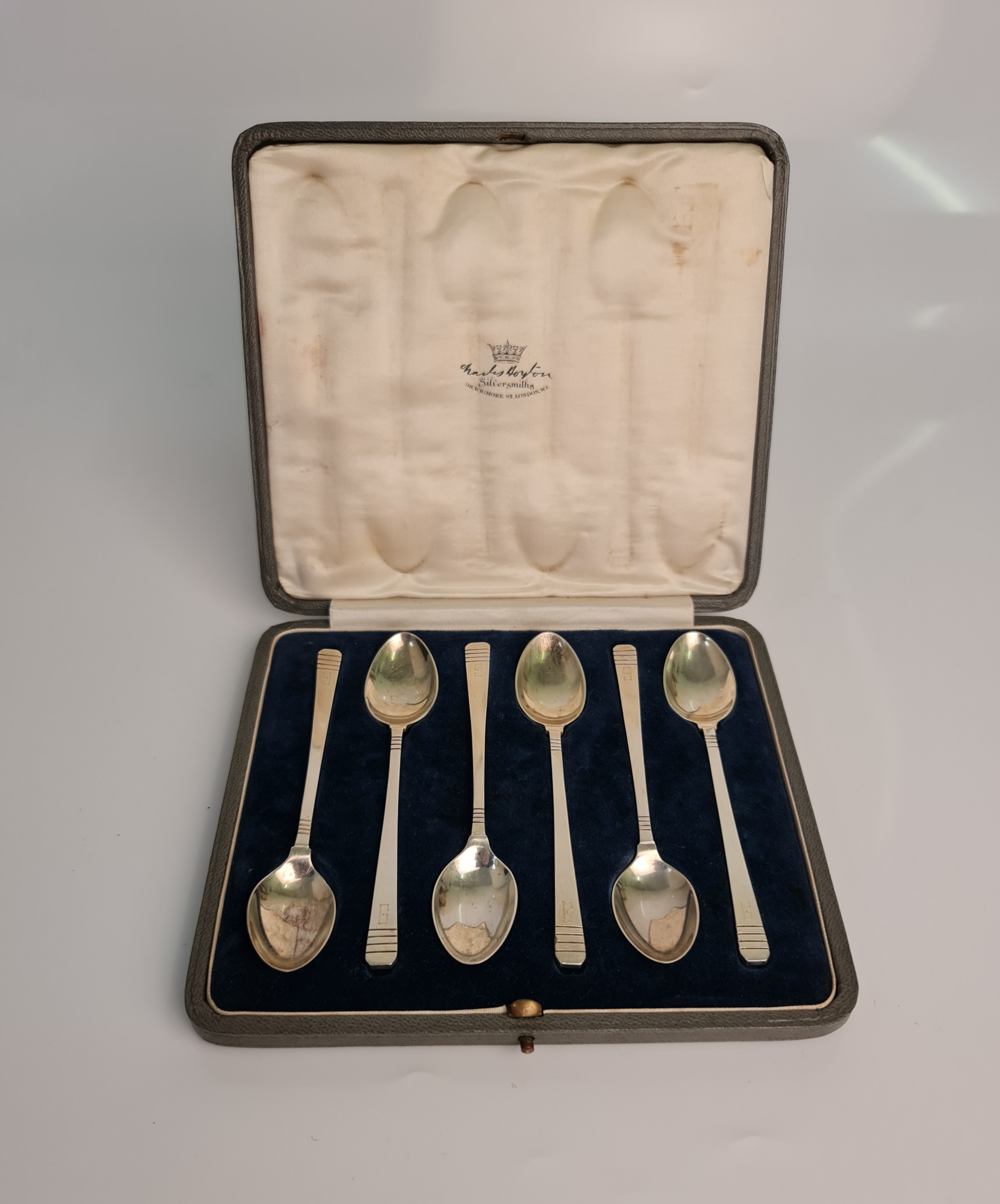 A boxed set of six Art Deco silver spoons, engraved with initial 'G', hallmarked London 1931 (one