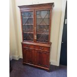 An reproduction mahogany glazed top two door display cabinet/bookcase with cupboard