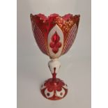 A bohemian cameo cranberry glass vase with gilt detail and crown rim to top, chips to some of the