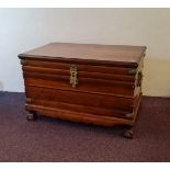 An African teak Iroko Kist trunk, with brass fittings and handles, on claw and ball feet, 65cm x