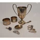 A selection of hallmarked silver to include two napkin rings, spoon, two handled trophy, approx.