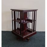 An Edwardian mahogany revolving bookcase with satinwood border inlay to top, approx. height 82cm.