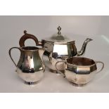 An Art Deco silver tea set, comprising teapot, sugar bowl and milk jug, hallmarked 1935/36,