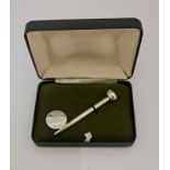 *A boxed golf tee with hallmarked Silver Ford ball marker, box states 'To commemorate your visit