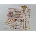 A selection of hallmarked silver to include, two toast racks, a jug, various spoons, powder puff pot