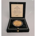 A 1992 United Kingdom £5 brilliant uncirculated gold coin in box, N0. 0327. IMPORTANT: Online