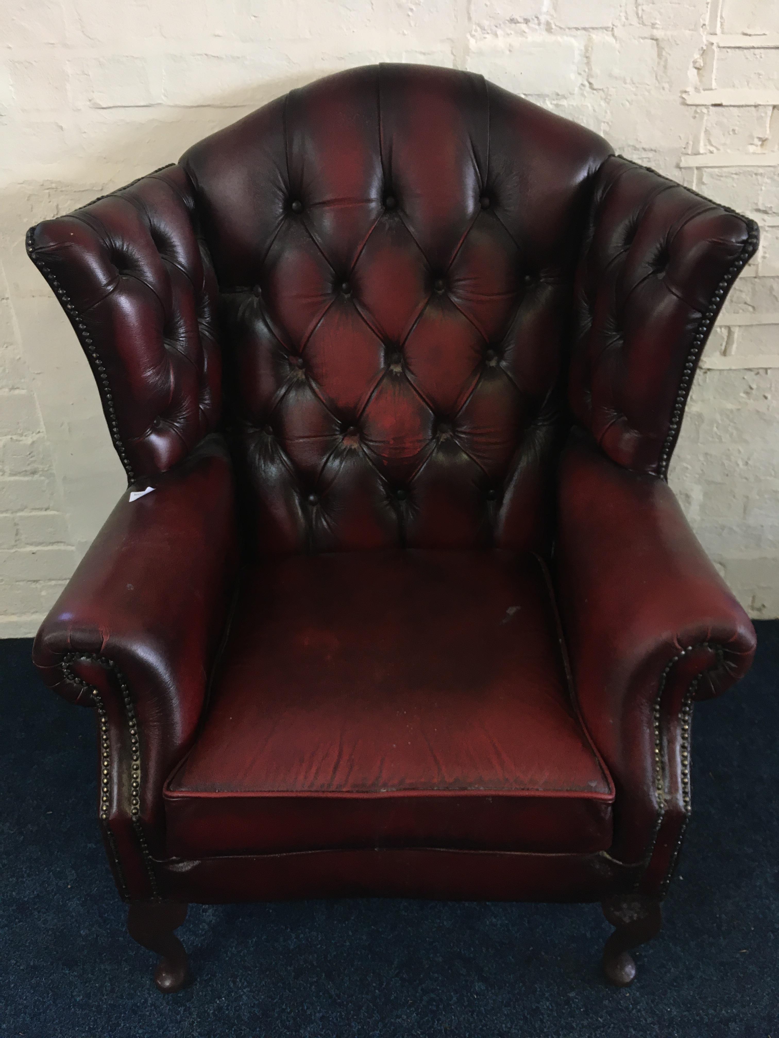 A modern ox blood leather fireside armchair. IMPORTANT: Online viewing and bidding only.