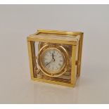 A Jens Olsen maritime style clock with brass and glass case. 8.5cm. IMPORTANT: Online viewing and