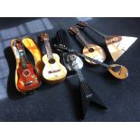 Seven various stringed instruments including ukeleles, mandolin, etc, some in cases. IMPORTANT: