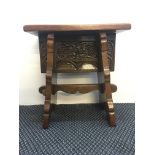 An oak reproduction 16th century style stool with carved grape vines panel. IMPORTANT: Online