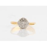 A diamond cluster ring, stamped 18ct, ring size M½. IMPORTANT: Online viewing and bidding only. No