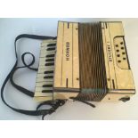 A Hohner Student I cream marbled piano accordion, in case. IMPORTANT: Online viewing and bidding