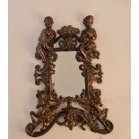 A cast iron bronze finished freestanding mirror, decorated with boy and girl holding fruit basket,