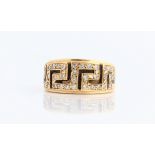 A gent's diamond dress ring, the geometric pattern set with round brilliant cut diamond accents,