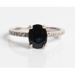 A sapphire doublet and diamond ring, set with an oval cut sapphire doublet and six round brilliant