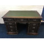 A 19th century carved oak twin pedestal desk with carved green man decoration. IMPORTANT: Online