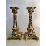 A pair of Royal Crown Derby Old Imari 1128 three part candlesticks XLI and XLII, top rim to one