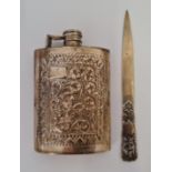 A hip flask, featuring repousse floral and scroll design, stamped SILVER, together with a letter