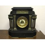 A black slate classical temple style mantel clock with brass columns and battle scene