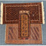 Two Afghan rugs, together with a camel bag rug. IMPORTANT: Online viewing and bidding only.