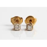 A pair of diamond studs, each diamond set with a round brilliant cut diamond, each 0.10ct, stamped