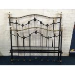 A Victorian style black painted with brass and porcelain fittings four foot six bed frame.