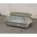 Two large galvanised feeding troughs.