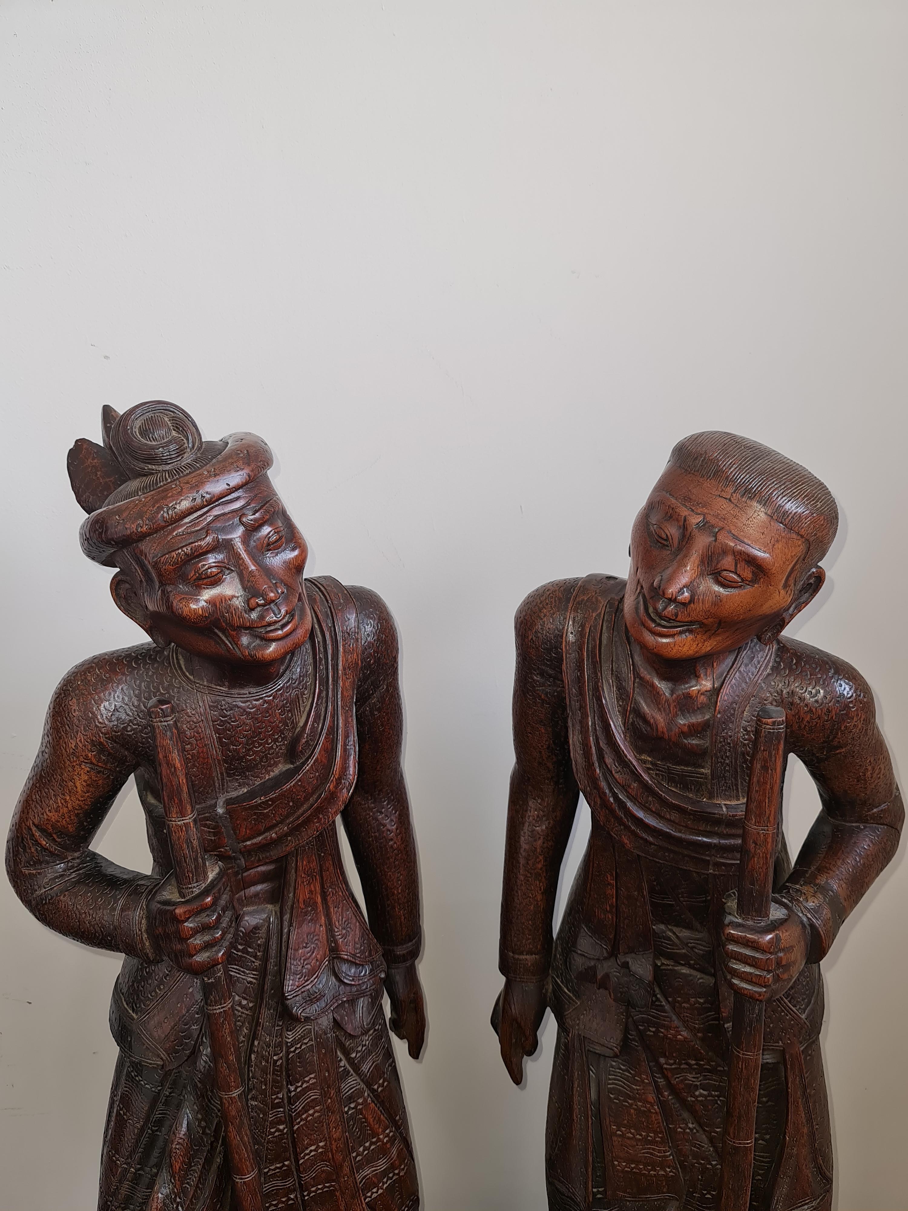 Two 19th century large oriental one piece carved wood male and female elderly traveller figures, - Image 2 of 6